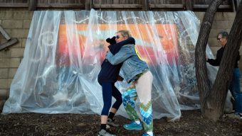Artists and friends add an image to the Great Wall of Topanga to honor resident Arthur Simoneau